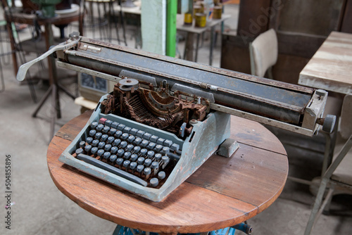 Fototapeta Naklejka Na Ścianę i Meble -  Old retro typewriter on table. Ancient printing technique in the closet.