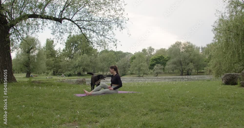 Portrait of a young woman practicing yoga in the garden. female happiness. in the background is a lake. Healthy lifestyle and concept of relaxation. Young woman doing yoga in the park Portrait of a young woman practicing yoga in the garden. female happiness. in the background is a lake. Healthy lifestyle and concept of relaxation. Young woman doing yoga in the park