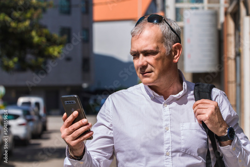 tourist on the street with backpack and mobile phone