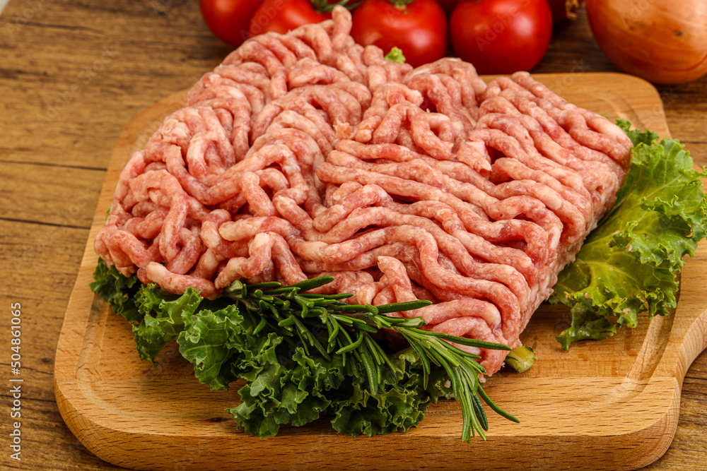 Raw pork minced meat over board Raw pork minced meat over board