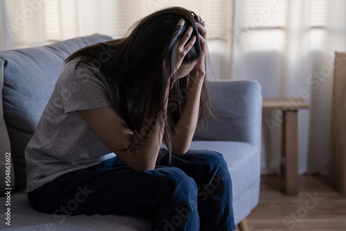 Mental health, depressed sad asian young woman, girl sitting on sofa, couch, expression to face difficulty, failure and exhausted. Thoughtful worried suffering depression feeling lonely, alone at home