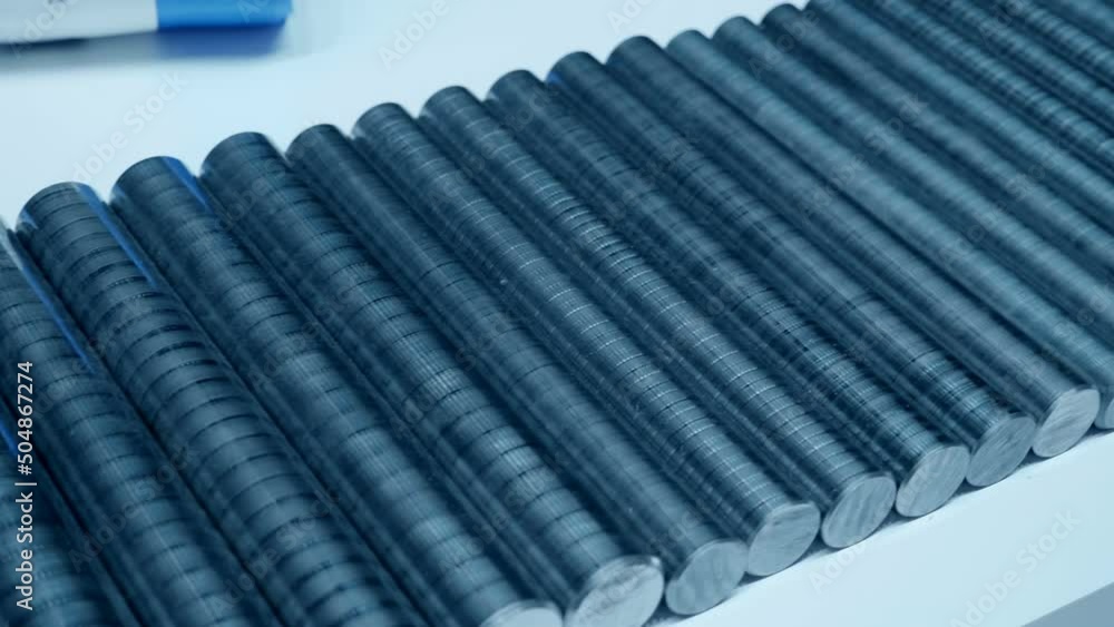 A lot of metal rods of different diameters as rough blanks for future parts after processing on the machine. Close up. Shot in motion A lot of metal rods of different diameters as rough blanks for future parts after processing on the machine. Close up. Shot in motion