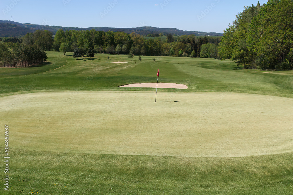 Obraz premium Golf course, meadow with green, bunker and flag
