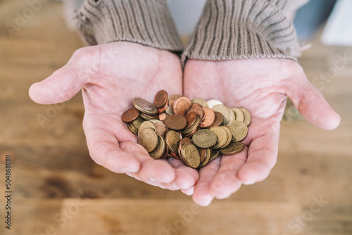 Close up of cupped hands with small change photo