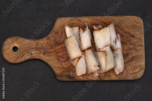 Dry salt salo, traditional Slavic food, slab of fatback frozen and thinly shaved photo