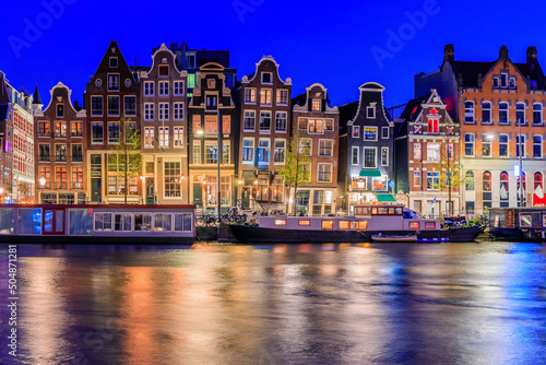 Amsterdam, Netherlands. Colorful dancing houses at the Damrak canal.