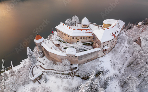 Lake Bled on a beautiful winter morning with mist and vivid clouds at sunrise