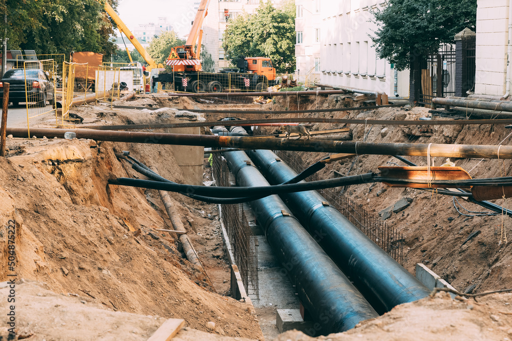 work area road repair, sewer repairs. tubes ground. maintenance area in city street. repair communications.