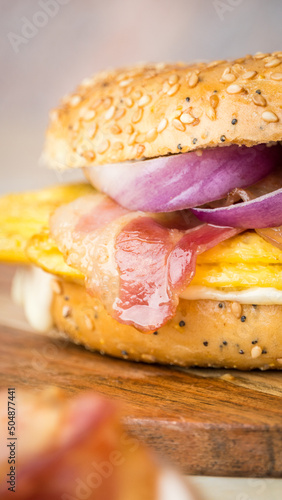 Mediterranean bagel with omelette, bacon, cheese and purple onion