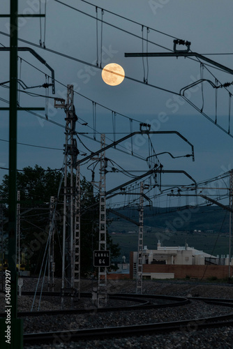 Full moon over the catenary suspension near the Ávila Railway station