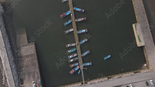 Aerial top down cirling of boats parked along the pier in port. Seosan, South Korea photo