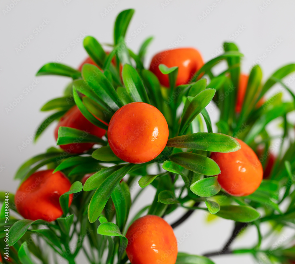 Artificial mandarin fruits on a white Stock Photo Adobe Stock