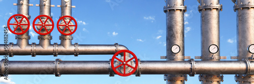 Fototapeta Industrial oil pipeline at a modern refinery with large red valves for cutting s