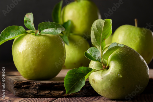 Leinwand Poster Raw Granny Smith apples. Green fresh fruits on dark background