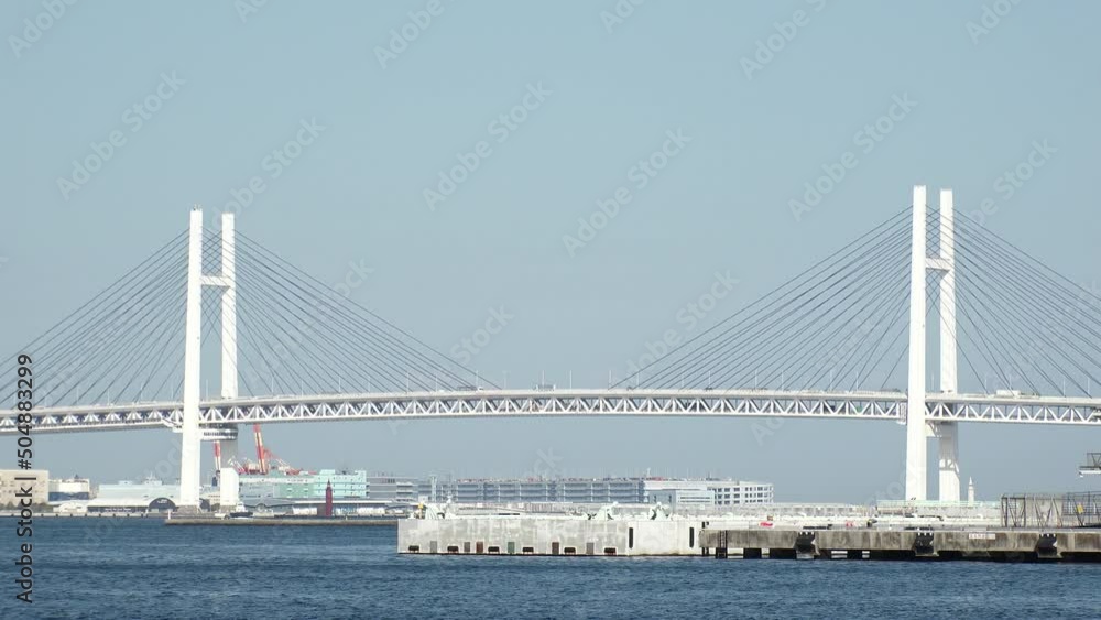 YOKOHAMA, KANAGAWA, JAPAN - APRIL 2022 : View of Yokohama Bay Bridge in daytime. It crosses Tokyo Bay with a span of 460 meters. YOKOHAMA, KANAGAWA, JAPAN - APRIL 2022 : View of Yokohama Bay Bridge in daytime. It crosses Tokyo Bay with a span of 460 meters.