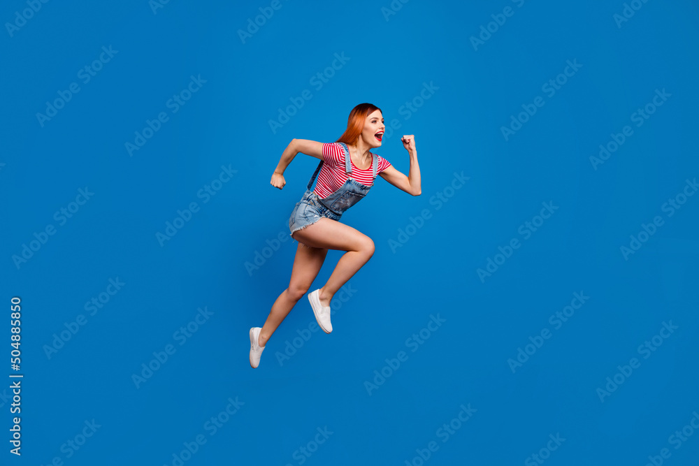 Full body portrait of energetic active person look empty space jump hurry fast isolated on blue color background Full body portrait of energetic active person look empty space jump hurry fast isolated on blue color background
