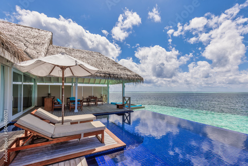 Fotografiet Deck chair with umbrellas at Maldives resort with infinity pool and beach, sea sky view