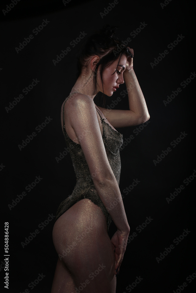 Fototapeta premium Portrait of a fashionable girl in the studio, dressed in bodysuite, sexy, make-up