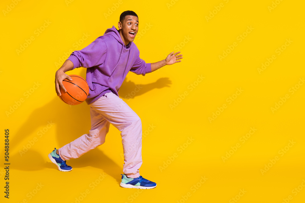 Full length body size view of attractive skilled guy playing soccer isolated over vibrant yellow color background