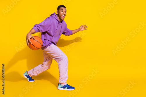 Full length body size view of attractive skilled guy playing soccer isolated over vibrant yellow color background © deagreez