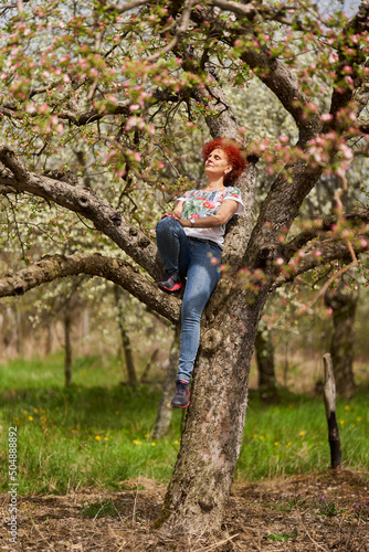 Redhead lady farmer in the apple orchard