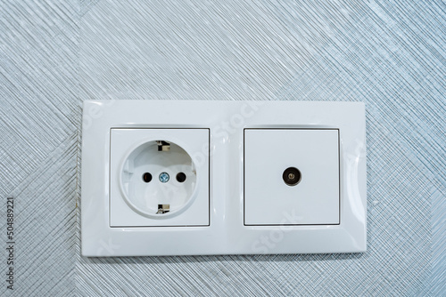 Socket combined with cable socket TV, electrical socket, socket installed on the wall in the room, white design of the panel on the plug of the electrical appliance.