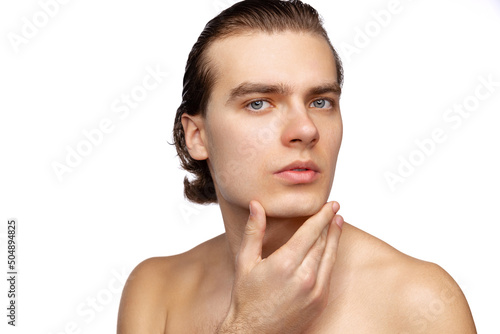 Close-up portrait of young handsome man isolated on white studio background. Concept of men's health, beauty, self-care, body and skin care.