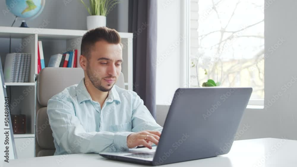 Young Teacher makes an Online Lesson while Sitting in Front of Computer at Home. The Workplace of the Tutor for School Lessons. Distant Study and Education Concept. Young Teacher makes an Online Lesson while Sitting in Front of Computer at Home. The Workplace of the Tutor for School Lessons. Distant Study and Education Concept.
