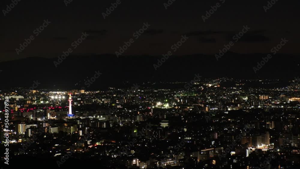 KYOTO, JAPAN - DECEMBER 2021 : Aerial high angle view of Kyoto city at night. Scenery of streets and buildings around Kyoto station. Time lapse shot. Japanese urban nightlife city concept video. KYOTO, JAPAN - DECEMBER 2021 : Aerial high angle view of Kyoto city at night. Scenery of streets and buildings around Kyoto station. Time lapse shot. Japanese urban nightlife city concept video.