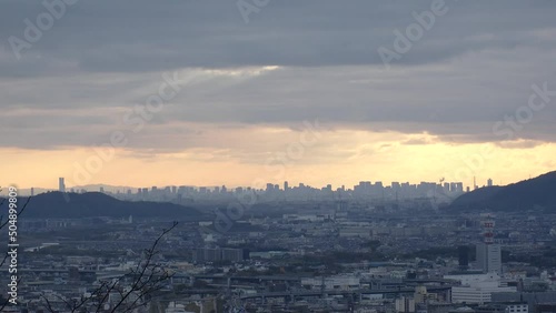 OSAKA, JAPAN - DECEMBER 2021 : Aerial panoramic view of downtown buildings at Osaka city in sunset time. View from Kyoto city in dusk. Japanese urban city concept video. photo