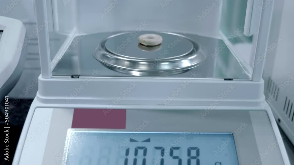 Digital laboratory balance with phenomenal accuracy determines the mass of any object of acceptable size. Closeup. Shot in motion Digital laboratory balance with phenomenal accuracy determines the mass of any object of acceptable size. Closeup. Shot in motion