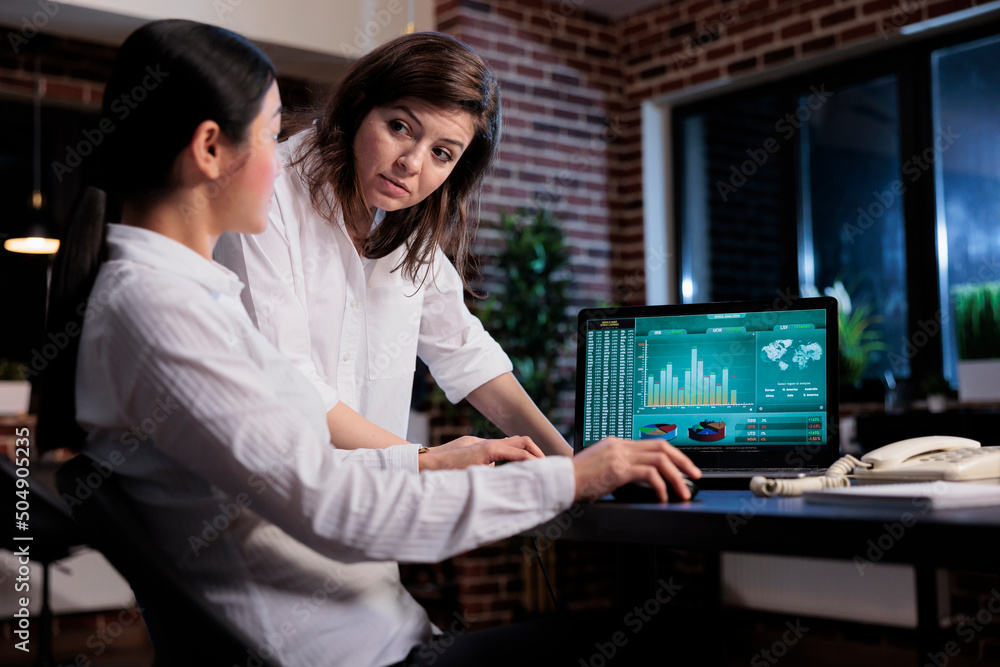 Business company office workers sitting at desk while reviewing startup project state. Executive board members discussing about bankruptcy possibility while analyzing financial data on laptop screen. Business company office workers sitting at desk while reviewing startup project state. Executive board members discussing about bankruptcy possibility while analyzing financial data on laptop screen.