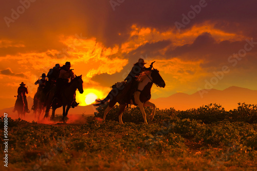 Fototapeta Naklejka Na Ścianę i Meble -  Group of Cowboy riding horse.
