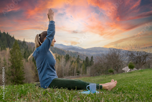 beautiful young women meditation yoga assana relaxing in nature in the mountains photo