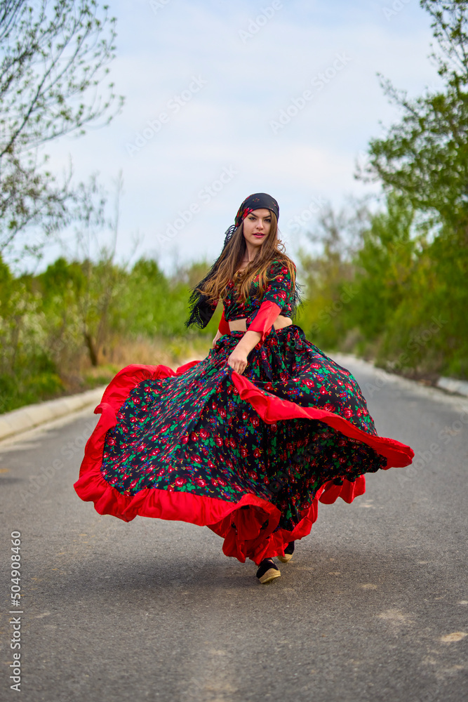 beautiful woman in traditional gypsy dress posing in nature in