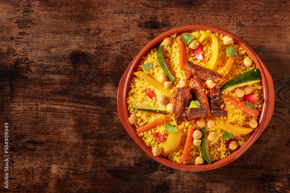 Ταπετσαρία Moroccan couscous with meat, traditional festive dinner, shot from above on a wo