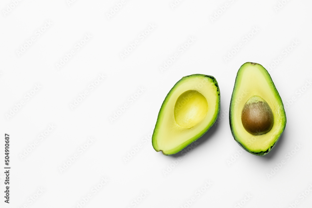 Top view of ripe and cut avocado on white background.