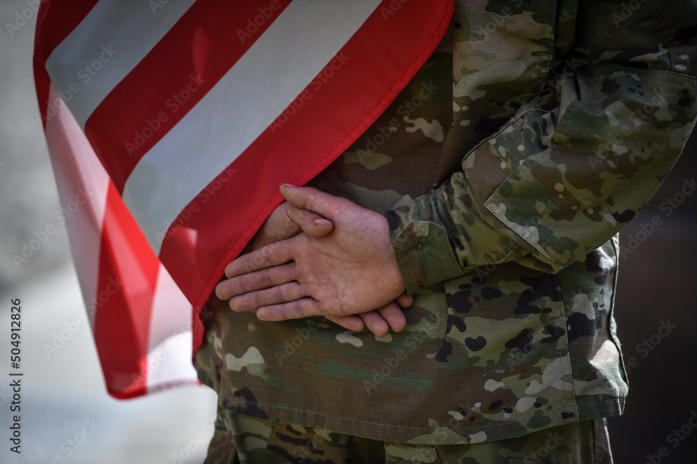 Detail shot with american soldier holding his hands in military standing position