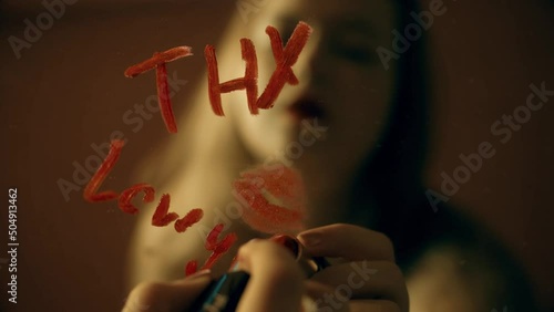 The girl writes a note on the mirror with red lipstick, thx kiss Thank you love you