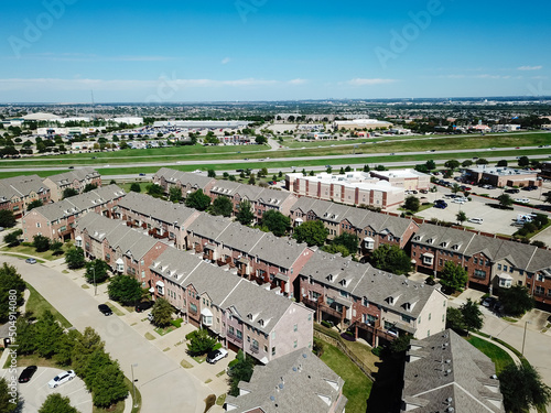 Canvas Print Aerial view row of new development three story townhomes with attached garages n