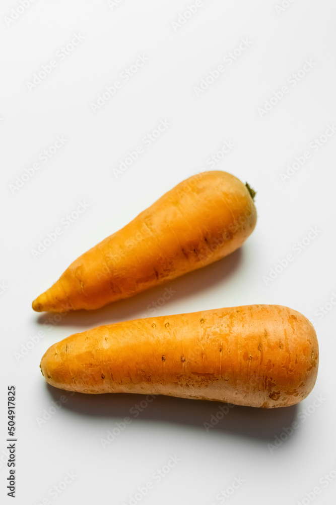 Top view of fresh carrots on white background. Top view of fresh carrots on white background.