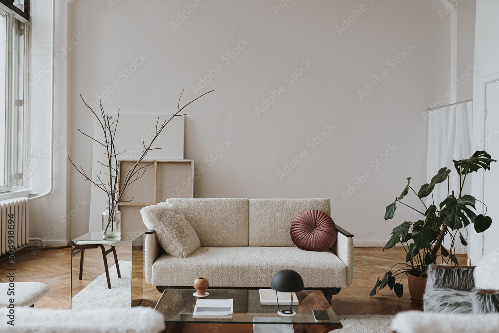 Elegant Scandinavian hygge style home living room interior: comfortable sofa, pillow, white walls, home plants. Aesthetic luxury bright apartment interior design concept - obrazy, fototapety, plakaty 