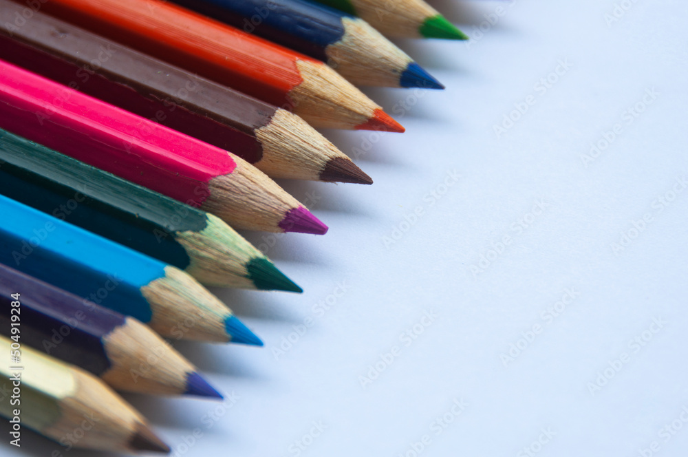 Colorful wooden pencil on white background. Copy space and educational concept Colorful wooden pencil on white background. Copy space and educational concept