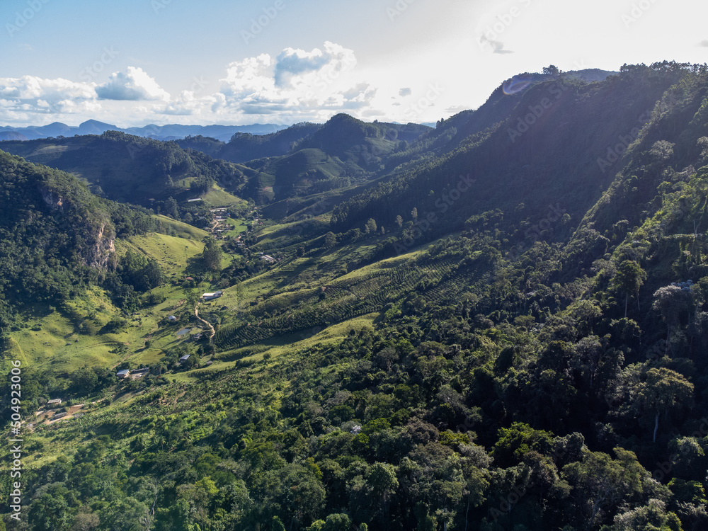 beautiful green valley with coffee, eucalyptus and banana plantation, drone aerial view - Venda Nova, Espirito Santo, Brazil