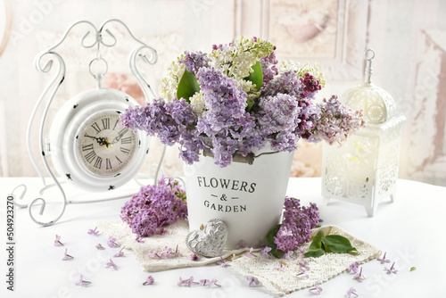Bouquet of colorful lilac blossoms in shabby chic interior