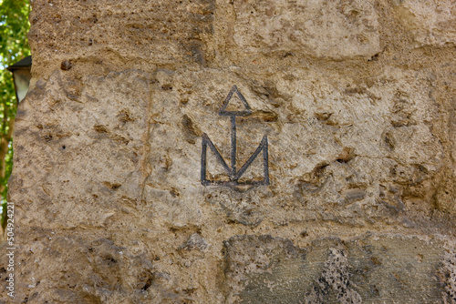 Stonemason mark carved on the ashlars of the Tenorio Tower. Archiepiscopal Palace of Alcala de Henares, Region of Madrid, Spain. photo