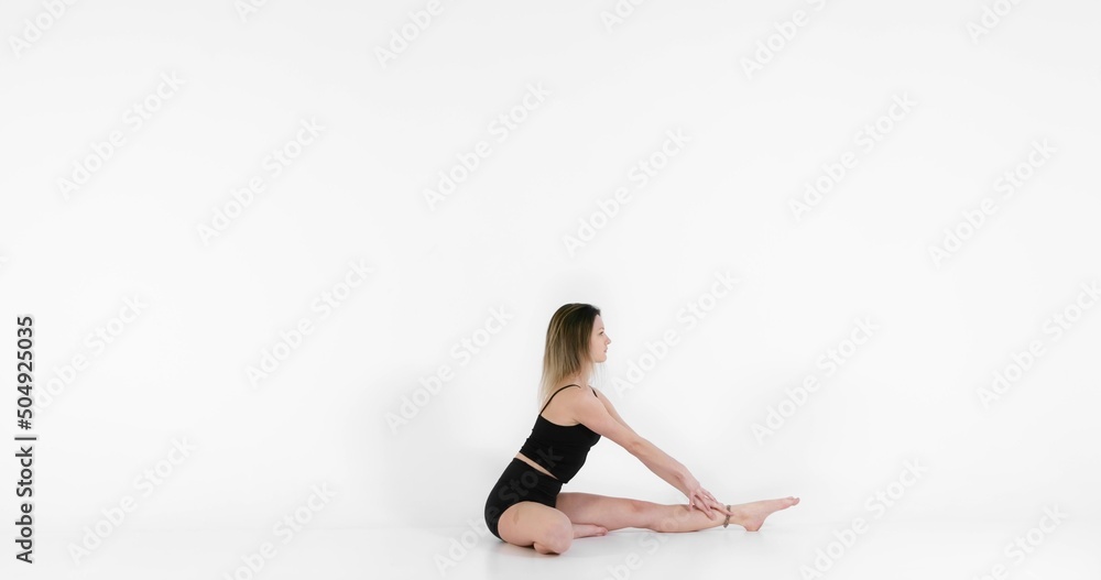 Fototapeta premium Blonde woman doing yoga exercise in studio closeup