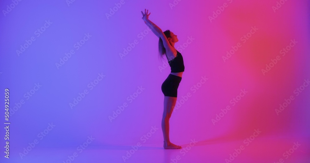 Blonde woman doing yoga in studio closeup