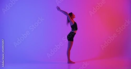 Blonde woman doing yoga exercise in studio closeup