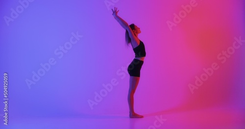 Blonde woman doing yoga in studio closeup